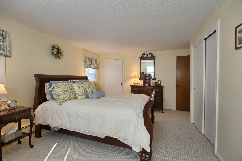 25 Autumn Road Lunenburg, MA 01462 - Photo 16 of 26 a bedroom with a bed and dresser with mirror
