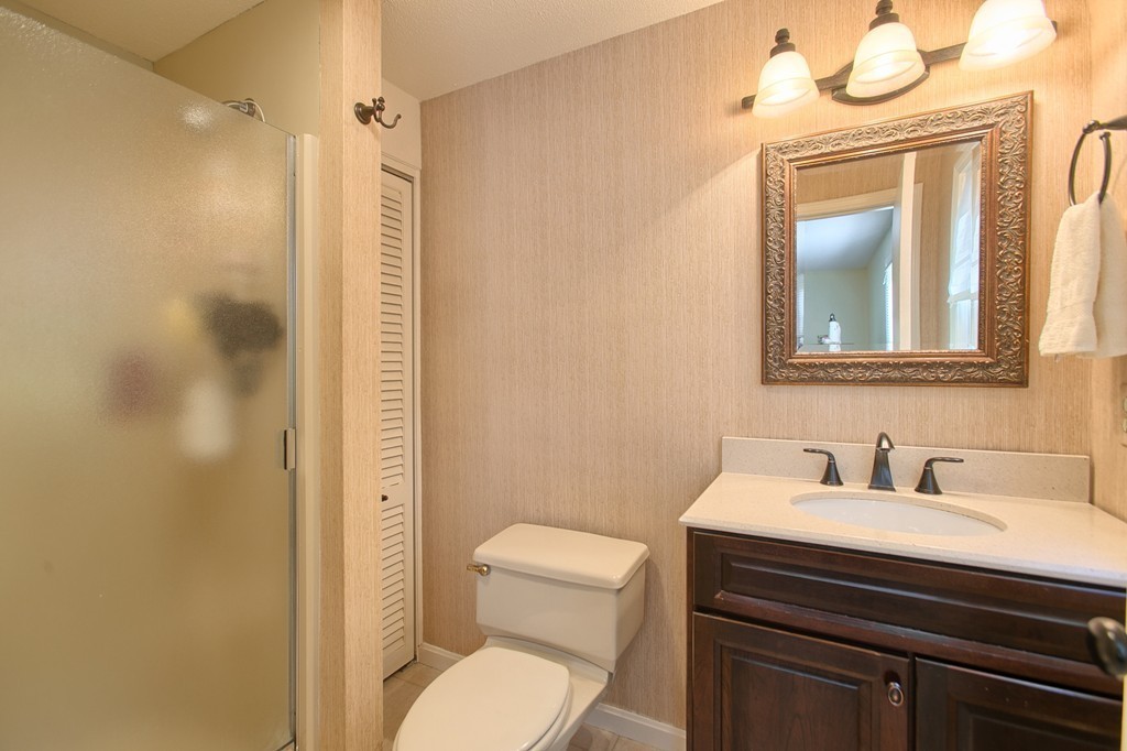 25 Autumn Road Lunenburg, MA 01462 - Photo 20 of 26 a bathroom with a toilet a sink and mirror