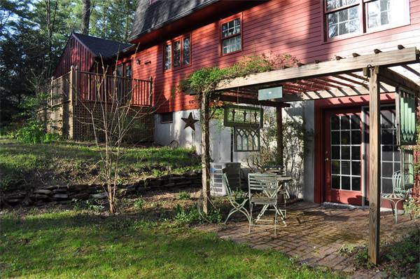 131 Aubinwood Road Amherst, MA 01002 - Photo 6 of 30 a view of a chair and table in backyard of the house