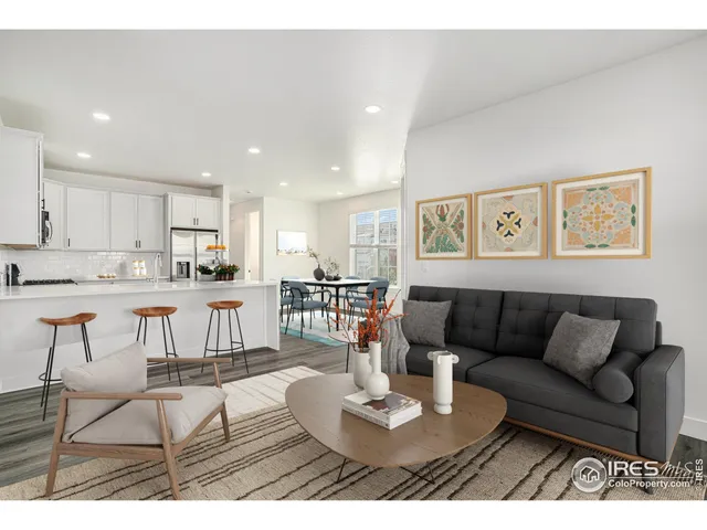 a living room with furniture and kitchen view