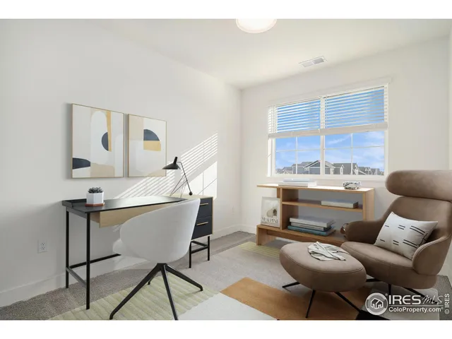 a living room with furniture a rug and white walls