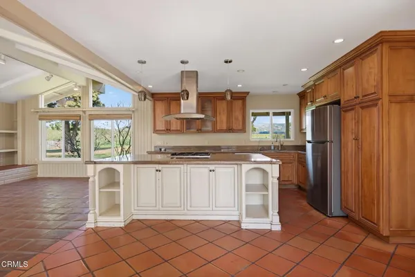 a large kitchen with stainless steel appliances granite countertop a stove a sink dishwasher and a microwave oven with white cabinets