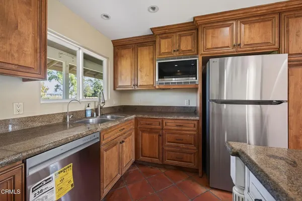 a bathroom with a granite countertop sink a mirror and shower