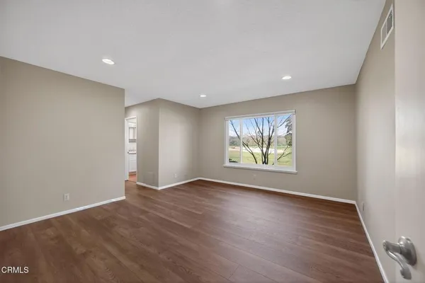 a patio with a table and chairs and potted plants