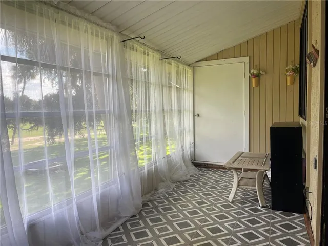 a view of a room with wooden floor and windows