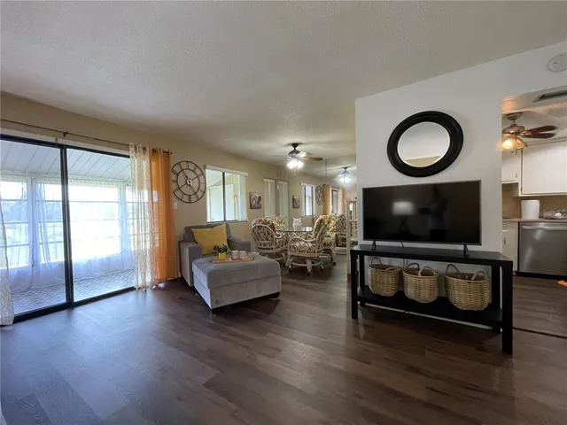 a kitchen with stainless steel appliances granite countertop a refrigerator a stove a sink and a microwave