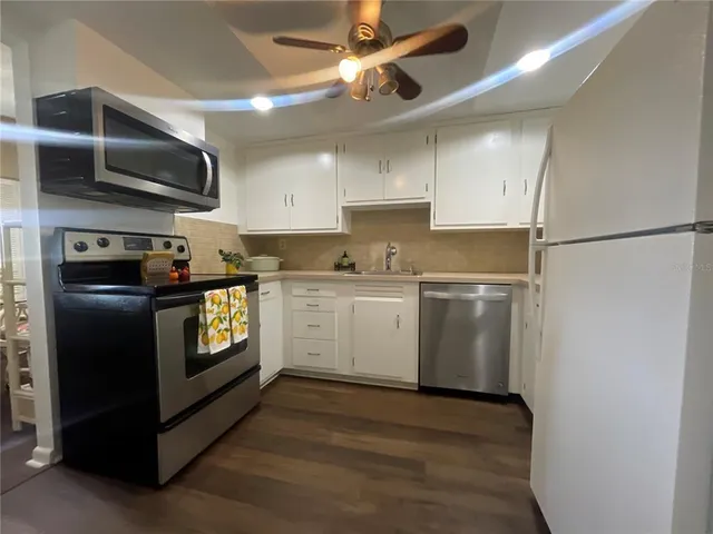 a kitchen with a sink and a refrigerator
