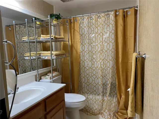 a bathroom with a shower curtain and a sink