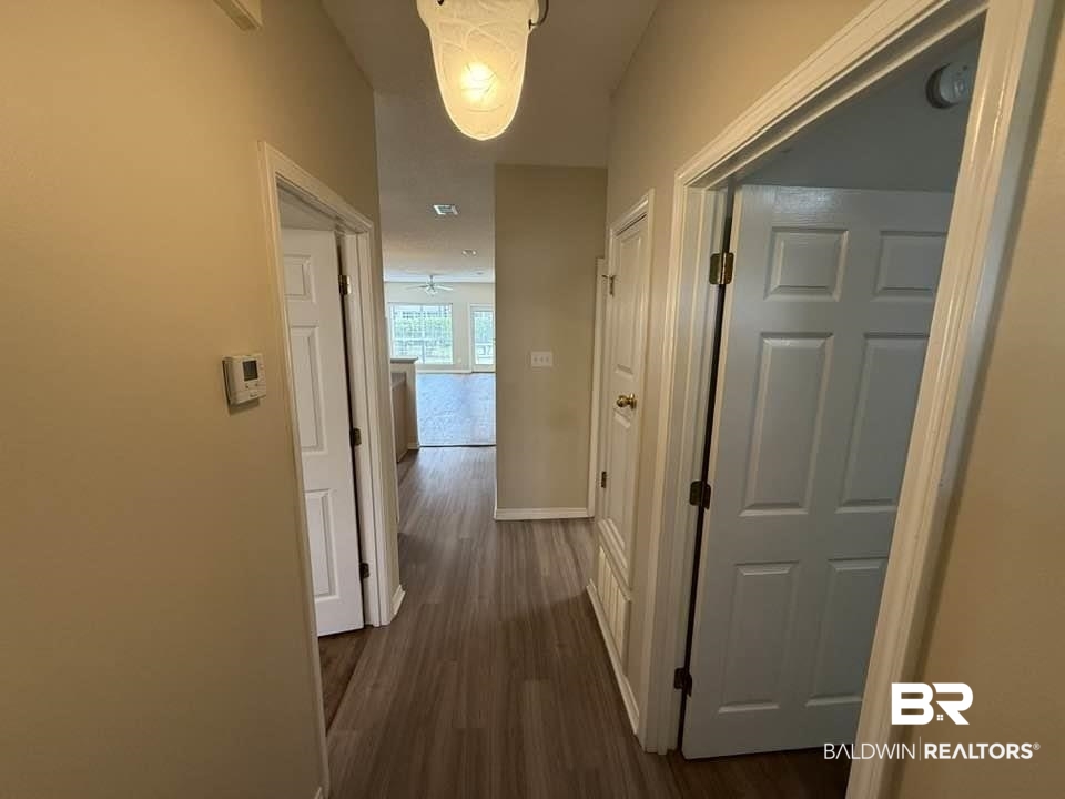 2651 South Juniper Street, Unit 401 Foley, AL 36535 - Photo 8 of 27 Corridor featuring dark wood-type flooring and baseboards