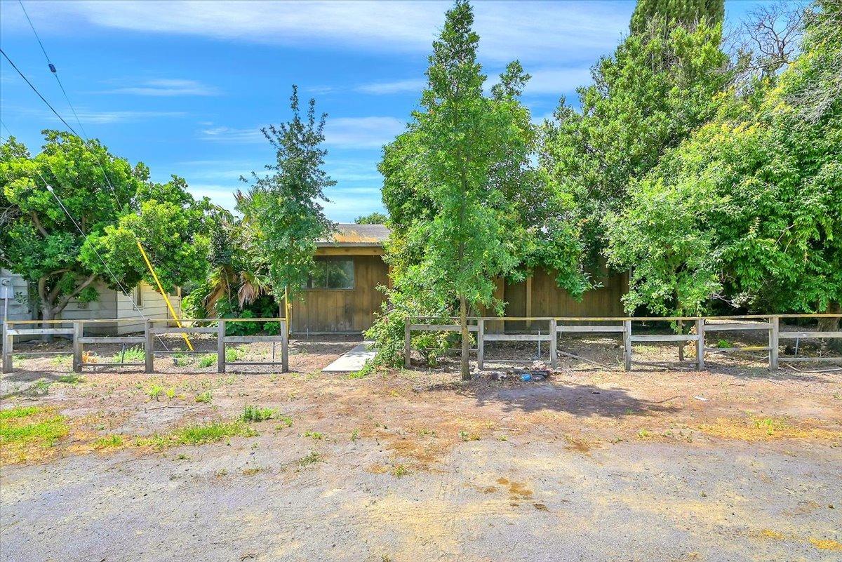a backyard of a house with table and chairs