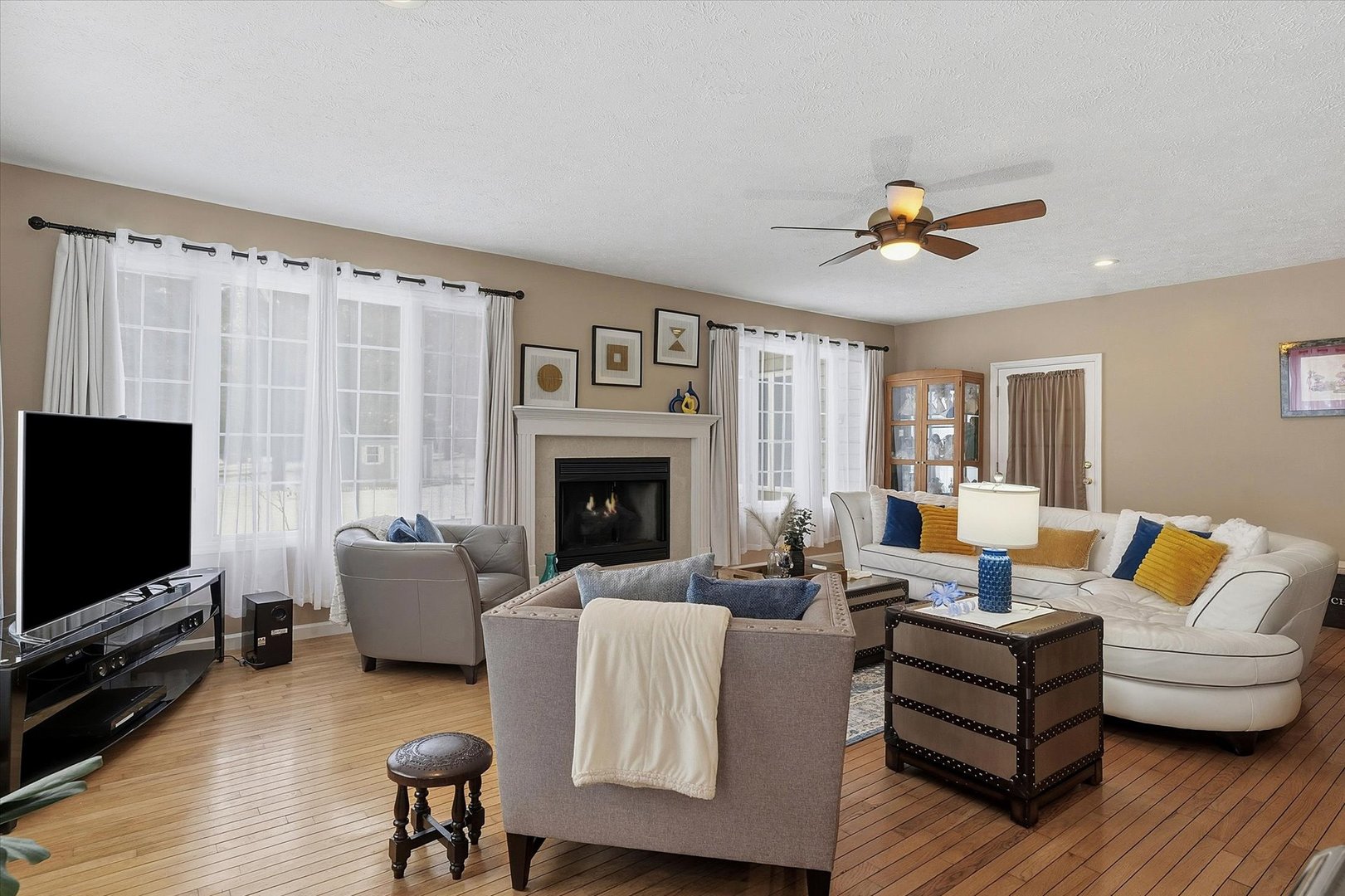 1307 Cross Creek Road Mahomet, IL 61853 - Photo 14 of 75 a living room with furniture a fireplace and a flat screen tv