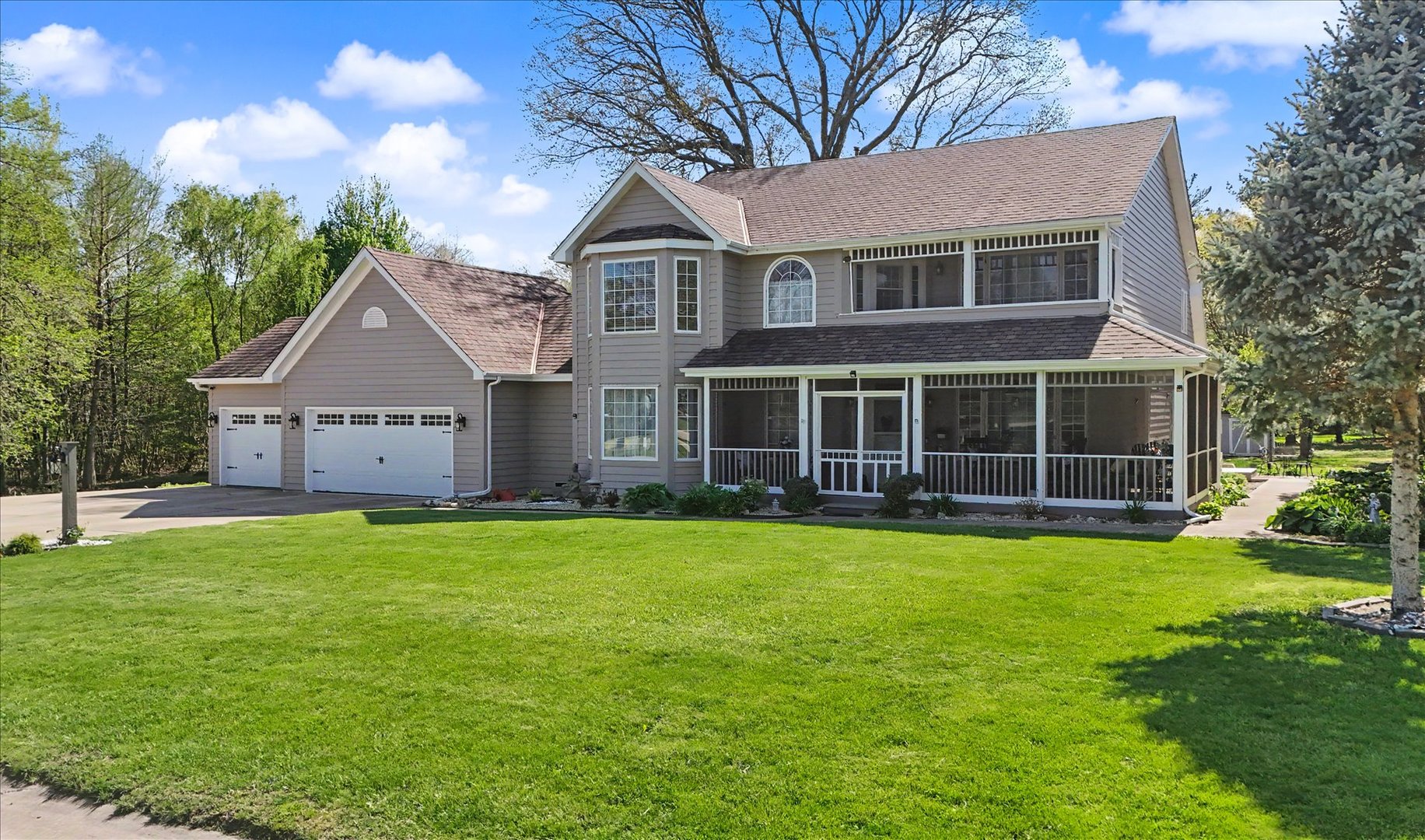 1307 Cross Creek Road Mahomet, IL 61853 - Photo 2 of 75 a view of a house with a yard and a large tree