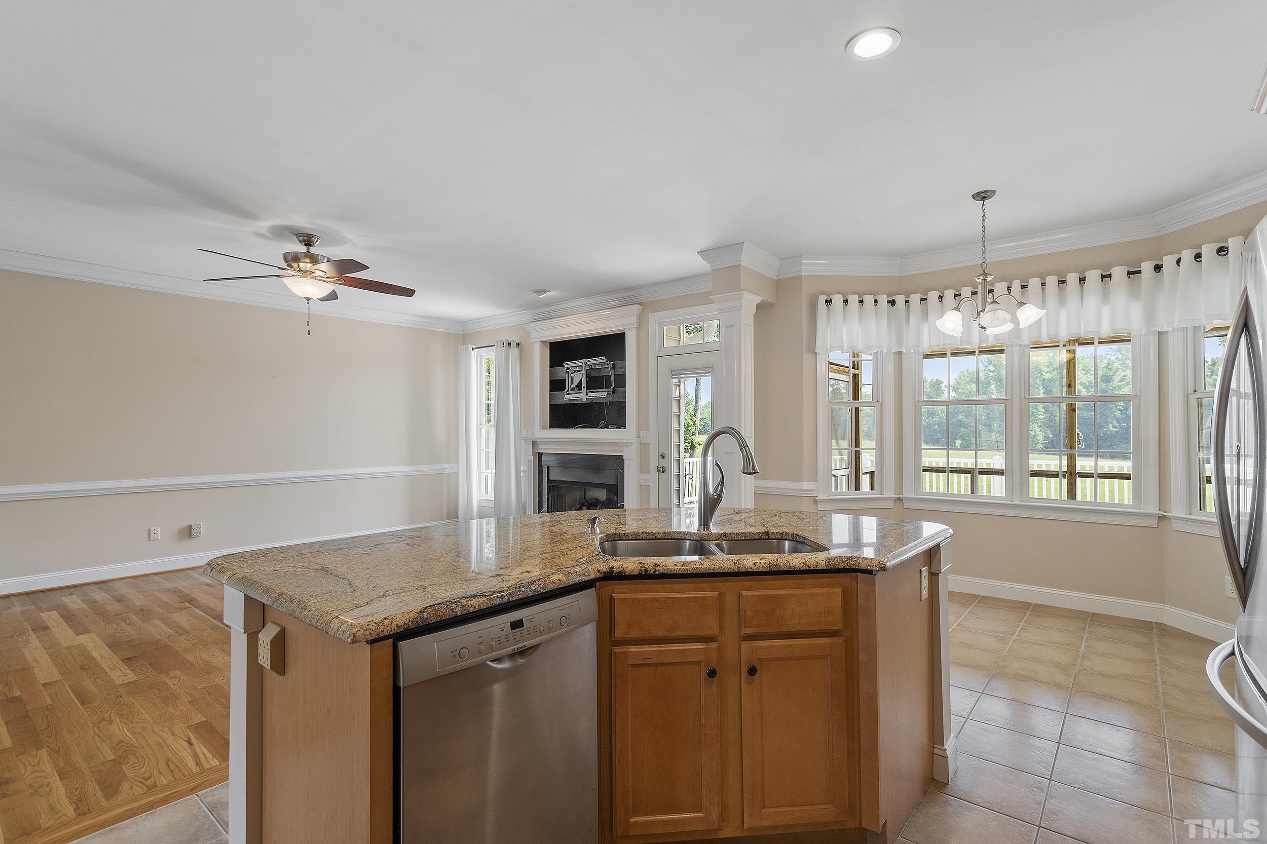 90 Fletcher Ridge Road Timberlake, NC 27583 - Photo 11 of 26 a kitchen with granite countertop a sink cabinets and window