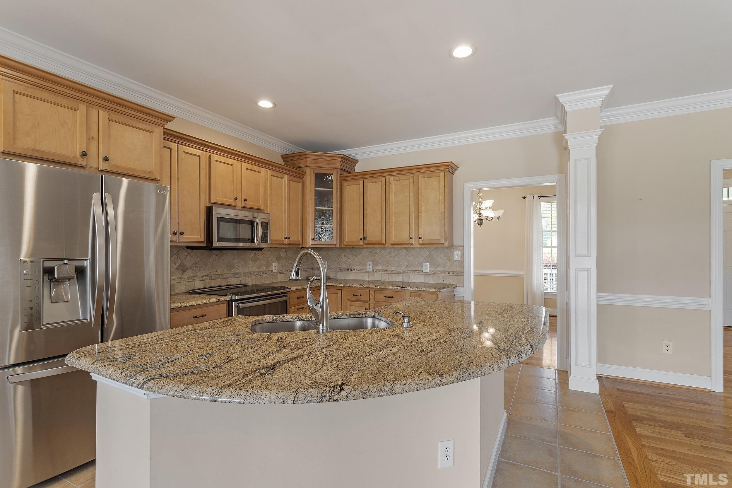 90 Fletcher Ridge Road Timberlake, NC 27583 - Photo 12 of 26 a kitchen with stainless steel appliances granite countertop a sink a stove and a refrigerator