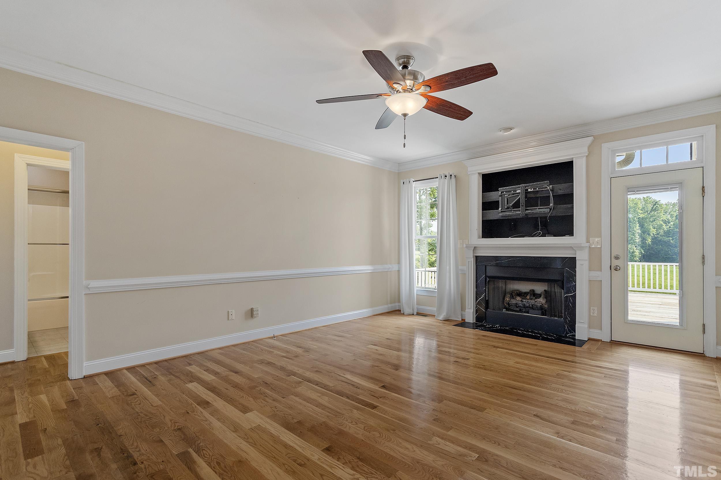 90 Fletcher Ridge Road Timberlake, NC 27583 - Photo 14 of 26 an empty room with windows fireplace and fan