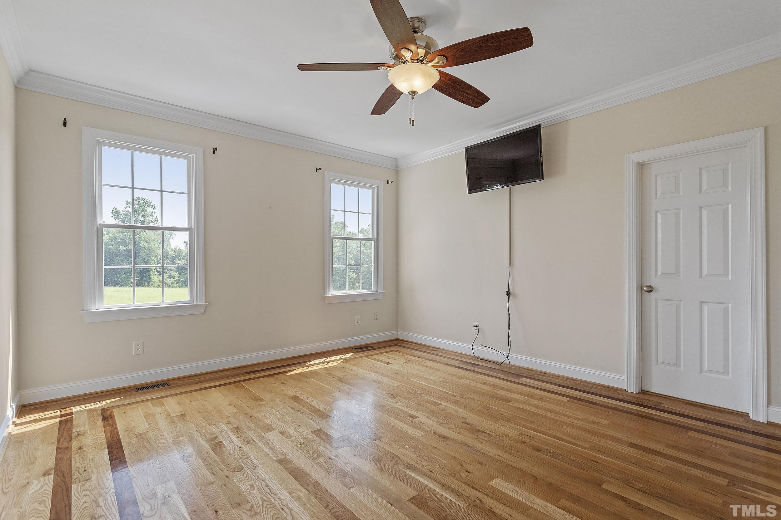 90 Fletcher Ridge Road Timberlake, NC 27583 - Photo 17 of 26 a view of an empty room with a window and wooden floor