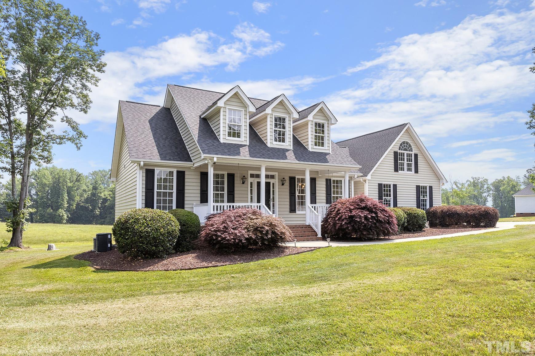 90 Fletcher Ridge Road Timberlake, NC 27583 - Photo 2 of 26 a front view of a house with garden