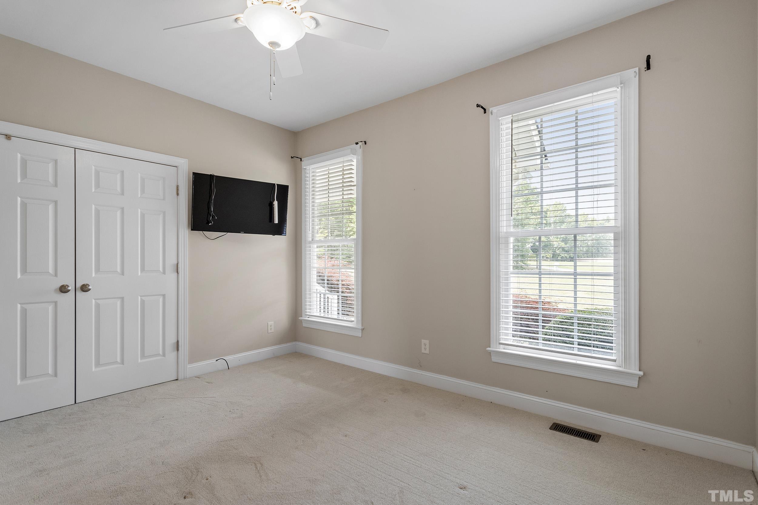 90 Fletcher Ridge Road Timberlake, NC 27583 - Photo 21 of 26 a view of livingroom with window a flat screen tv and a chandelier fan