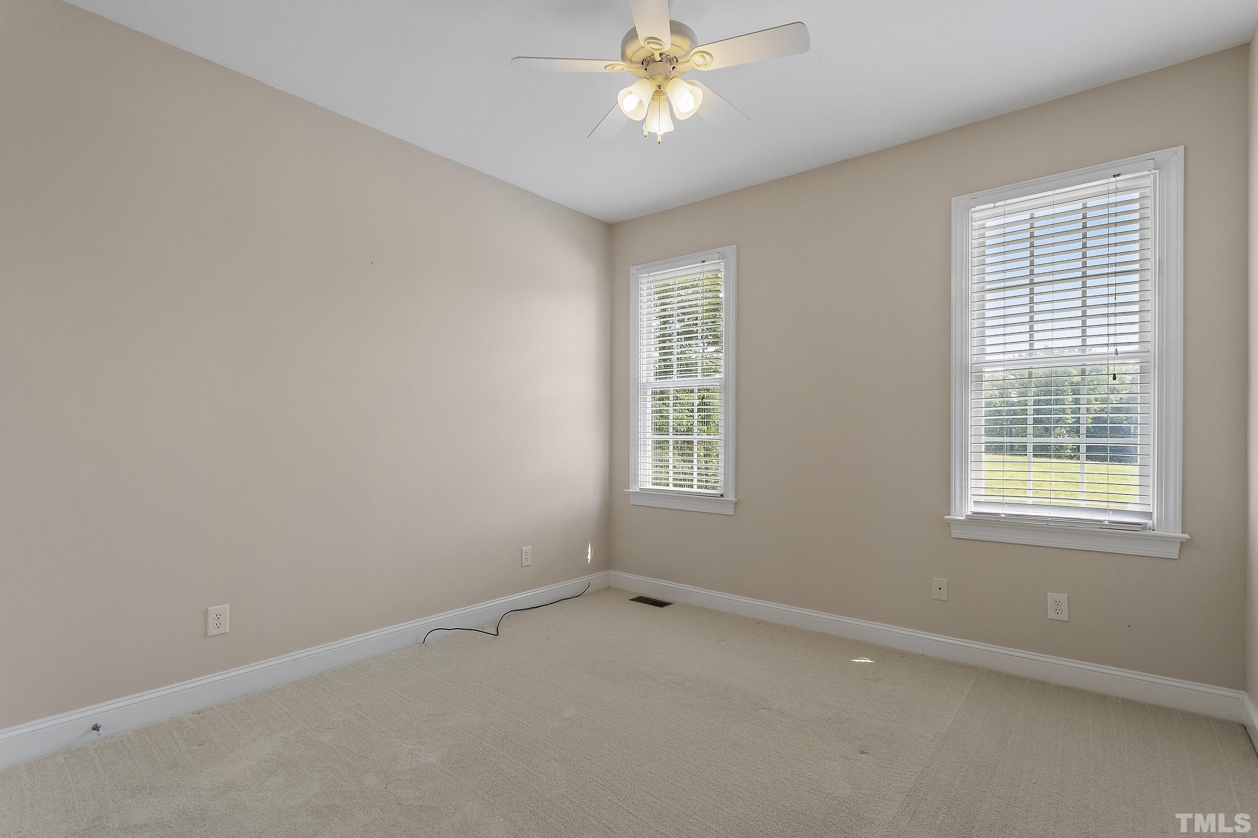 90 Fletcher Ridge Road Timberlake, NC 27583 - Photo 22 of 26 an empty room with a window and a fan