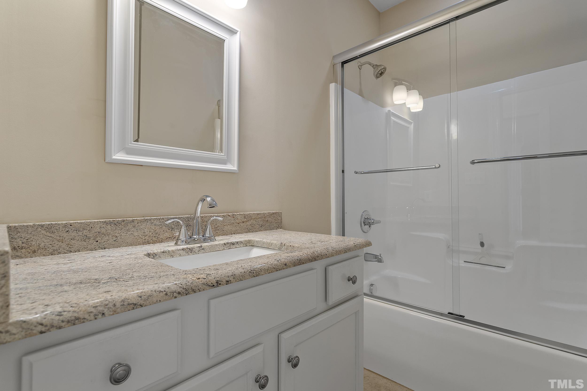 90 Fletcher Ridge Road Timberlake, NC 27583 - Photo 23 of 26 a bathroom with a granite countertop sink mirror and vanity