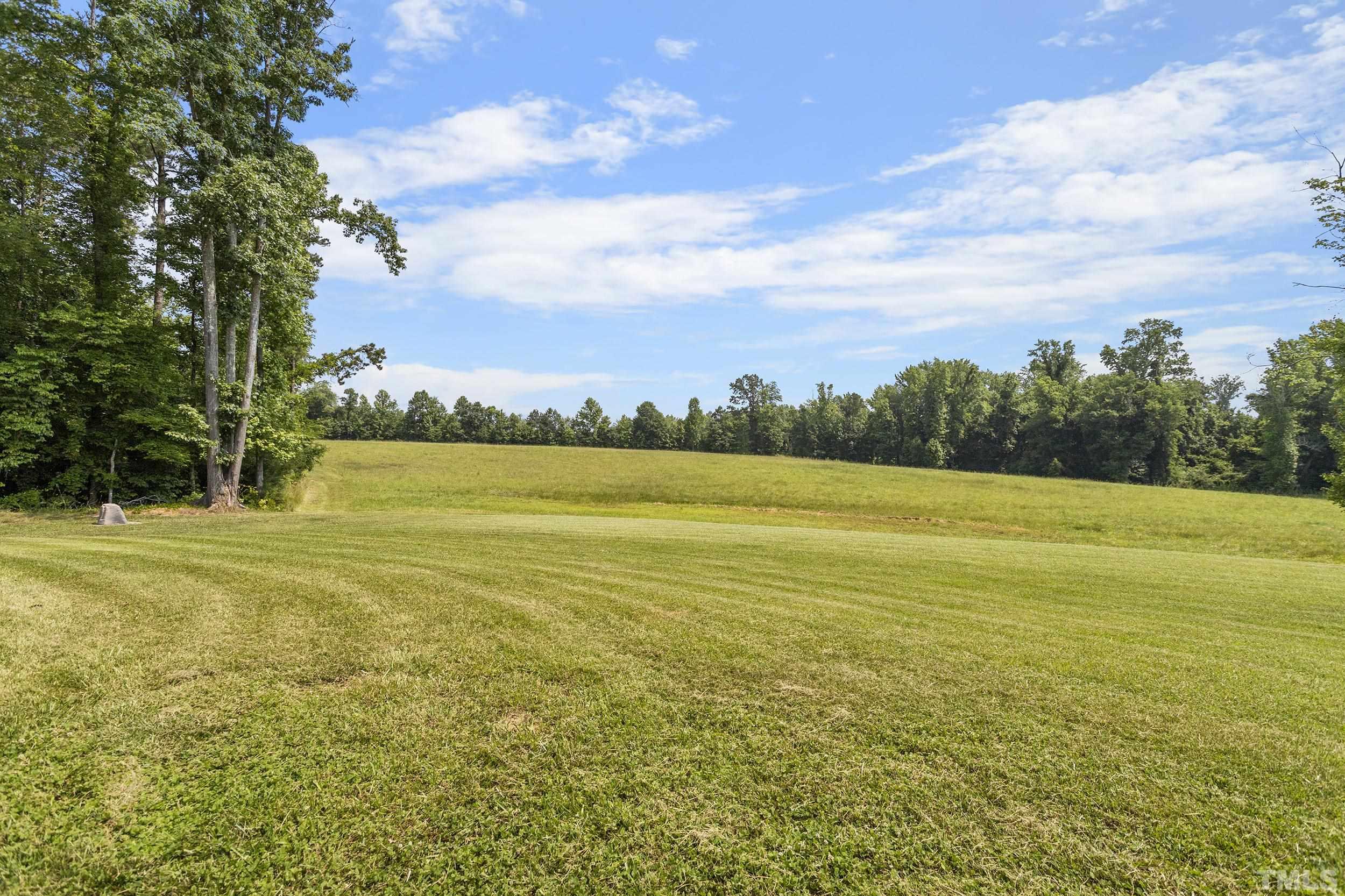 90 Fletcher Ridge Road Timberlake, NC 27583 - Photo 6 of 26 a view of an ocean and a yard
