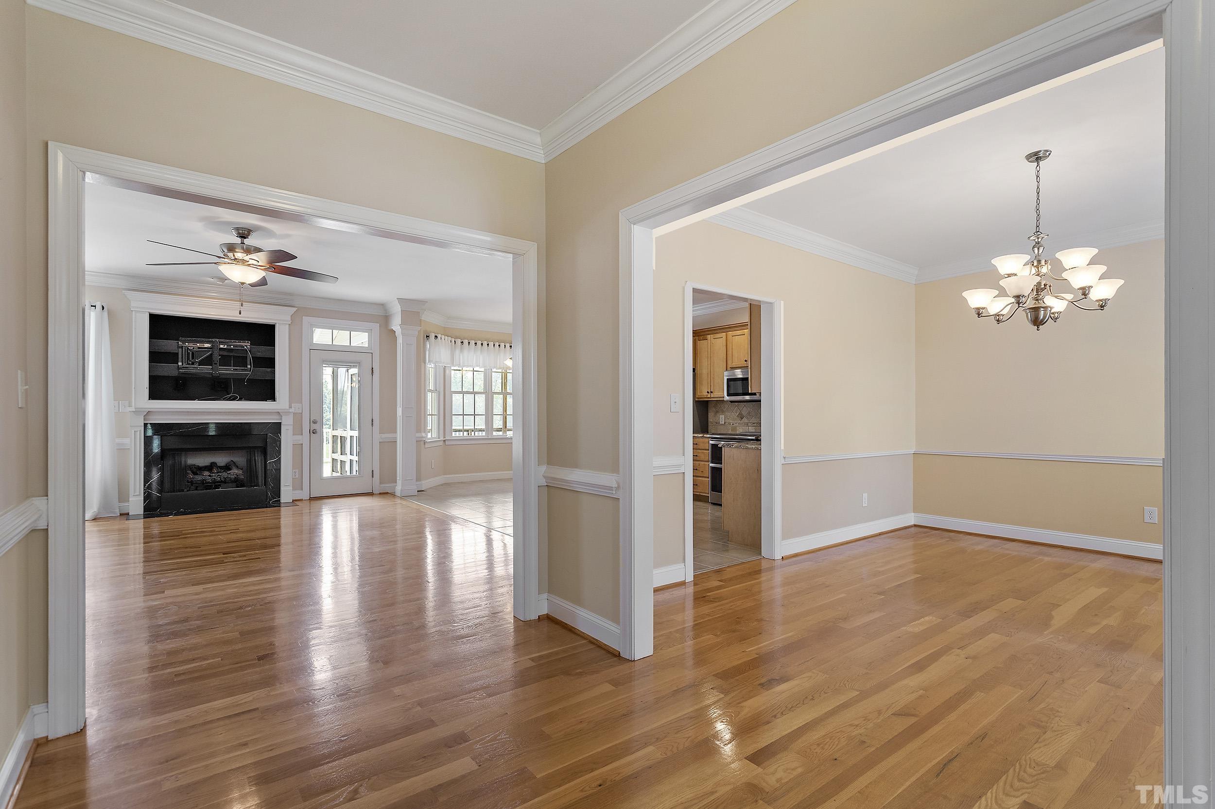 90 Fletcher Ridge Road Timberlake, NC 27583 - Photo 7 of 26 a view of an empty room with wooden floor and a kitchen