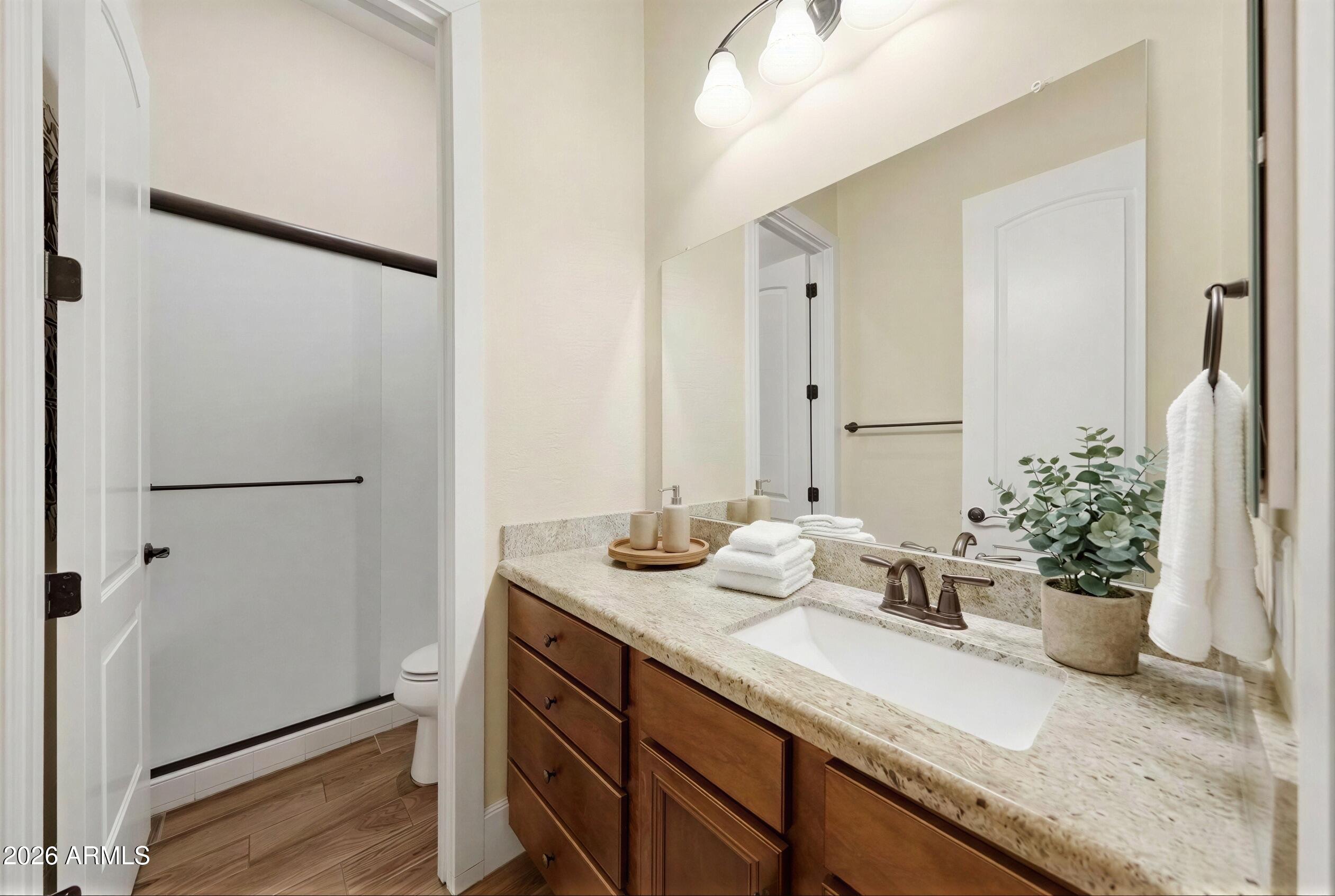 8974 North 8th Lane Phoenix, AZ 85021 - Photo 19 of 29 a bathroom with a granite countertop sink and a mirror