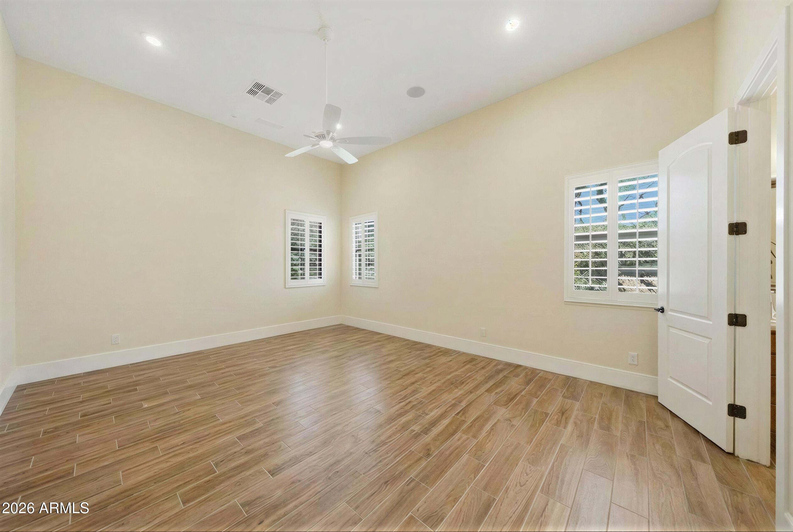 8974 North 8th Lane Phoenix, AZ 85021 - Photo 20 of 29 an empty room with wooden floor and windows