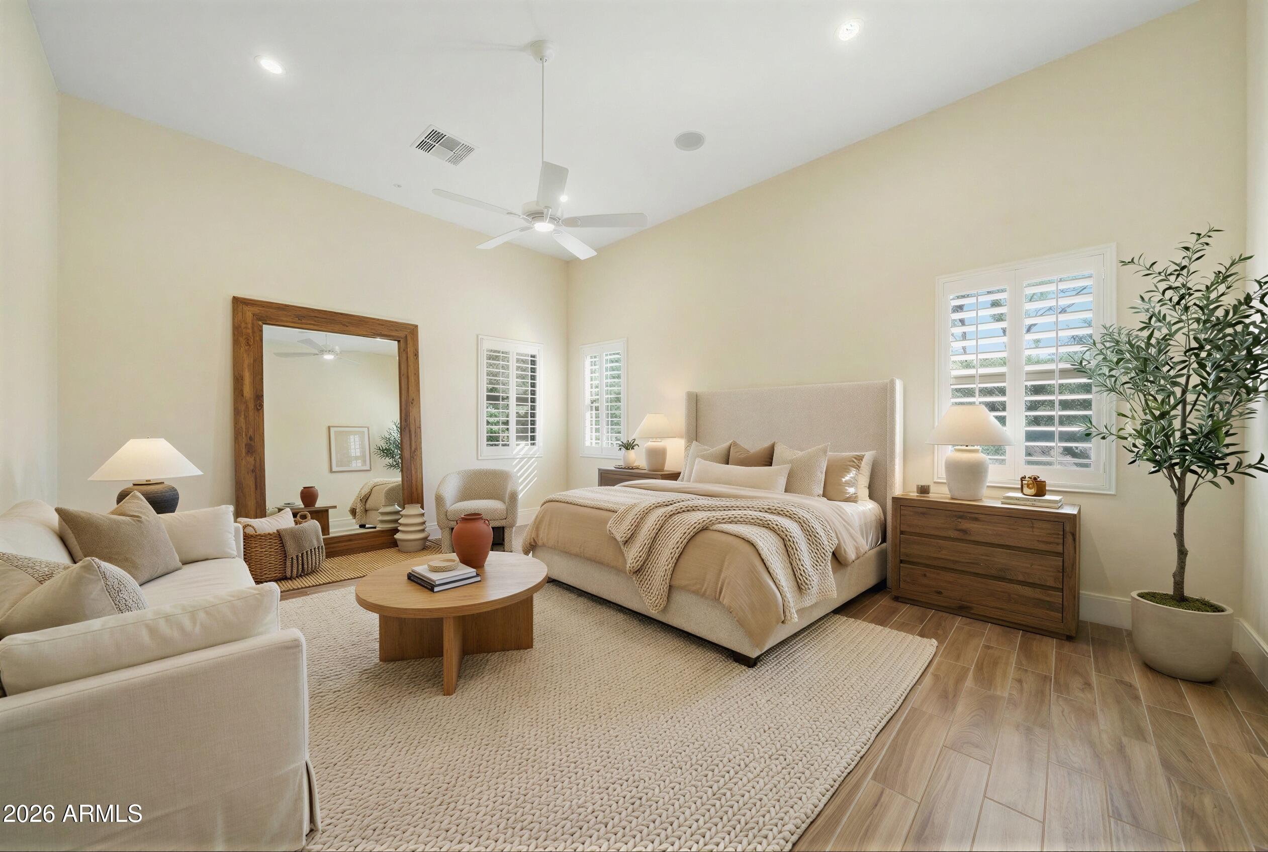 8974 North 8th Lane Phoenix, AZ 85021 - Photo 21 of 29 a spacious bedroom with a bed and a couch