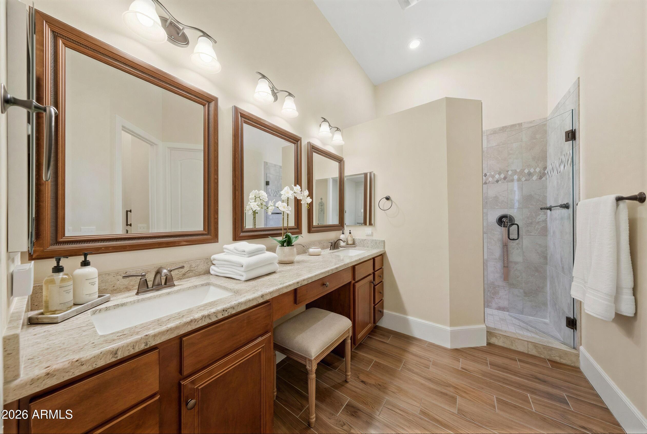 8974 North 8th Lane Phoenix, AZ 85021 - Photo 22 of 29 a bathroom with a granite countertop sink a mirror and a shower