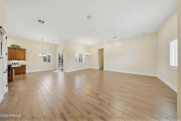 a view of kitchen and hall with wooden floor