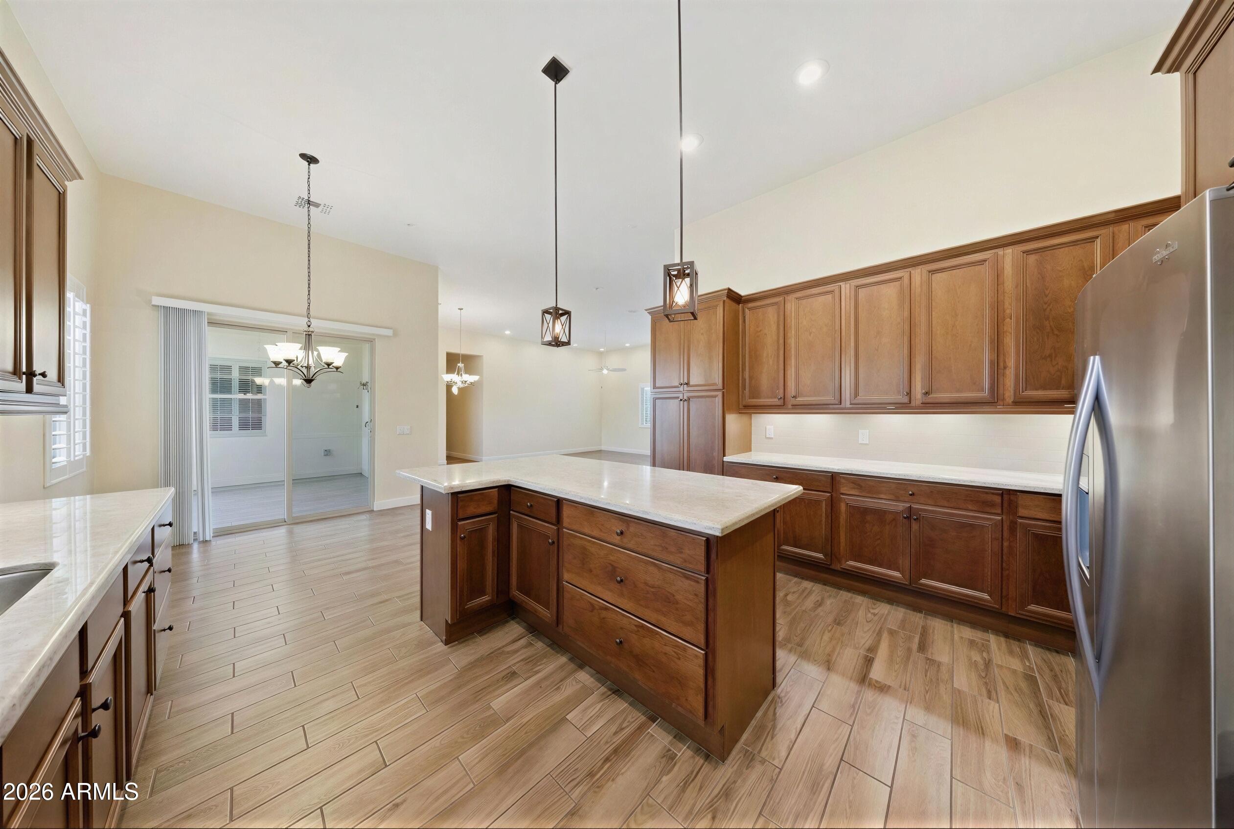 8974 North 8th Lane Phoenix, AZ 85021 - Photo 9 of 29 a kitchen with stainless steel appliances granite countertop a refrigerator a sink and wooden floors