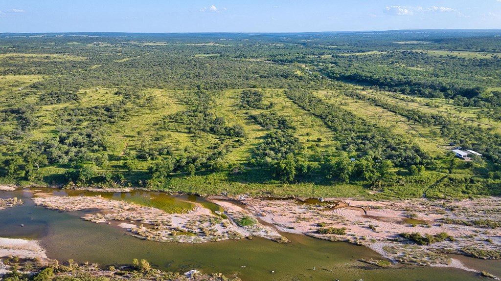 610 Ranch Road 152, Unit 4 Mason, TX 76856 - Photo 27 of 48 a view of a lake with a yard