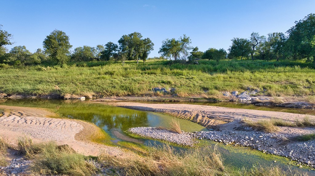 610 Ranch Road 152, Unit 4 Mason, TX 76856 - Photo 32 of 48 a view of a lake with a yard