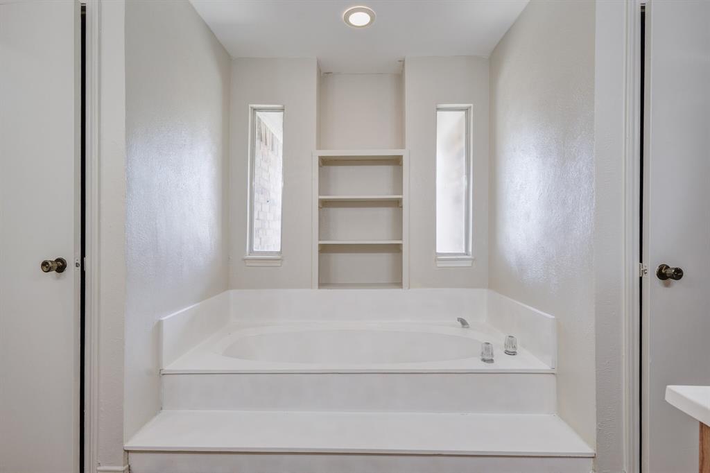 7305 Ridgeview Drive Rowlett, TX 75089 - Photo 11 of 32 a white bath tub sitting in a bathroom