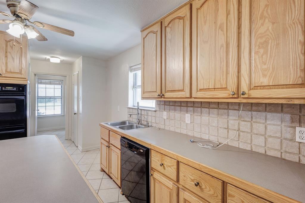 7305 Ridgeview Drive Rowlett, TX 75089 - Photo 20 of 32 a kitchen with a sink cabinets and window