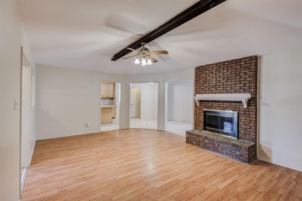 7305 Ridgeview Drive Rowlett, TX 75089 - Photo 31 of 32 a view of empty room with wooden floor and fireplace