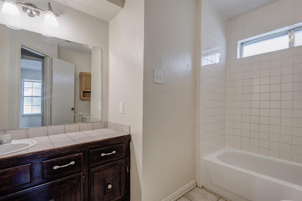 7305 Ridgeview Drive Rowlett, TX 75089 - Photo 5 of 32 a bathroom with a tub sink and mirror