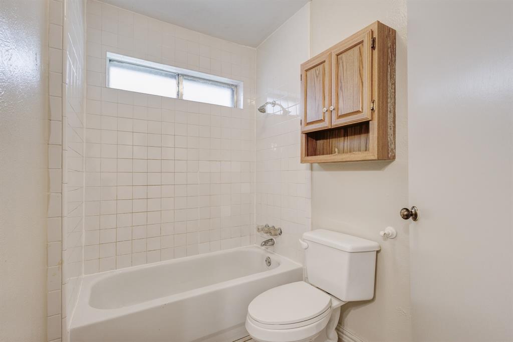 7305 Ridgeview Drive Rowlett, TX 75089 - Photo 6 of 32 a white bath tub sitting next to a white toilet