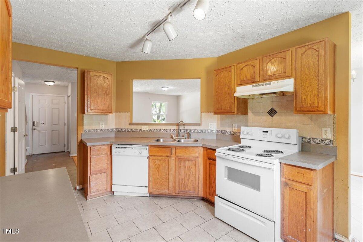 4221 Tensity Drive Raleigh, NC 27604 - Photo 11 of 31 a kitchen with stainless steel appliances a stove microwave and cabinets