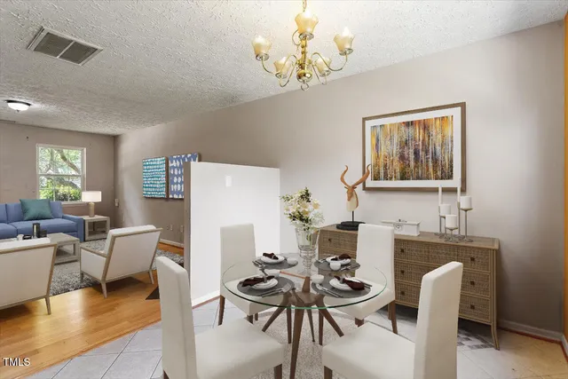a dining room with furniture a chandelier and wooden floor