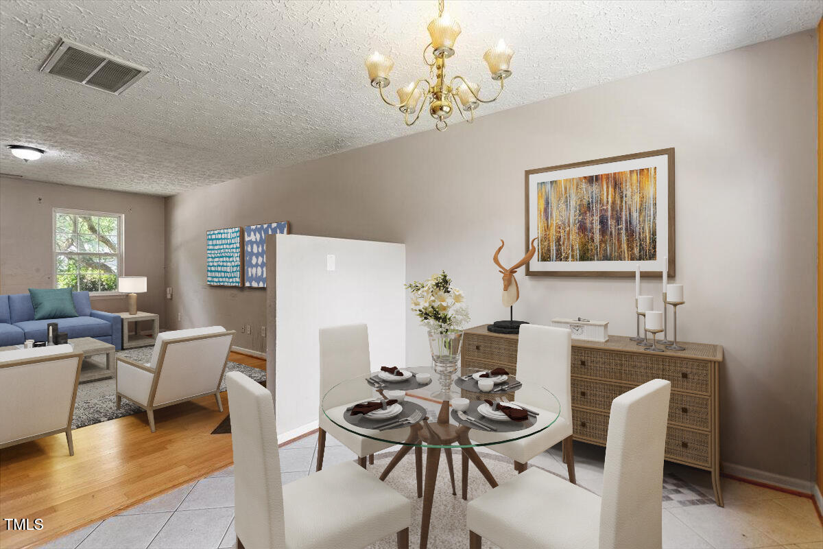 4221 Tensity Drive Raleigh, NC 27604 - Photo 13 of 31 a dining room with furniture a chandelier and wooden floor