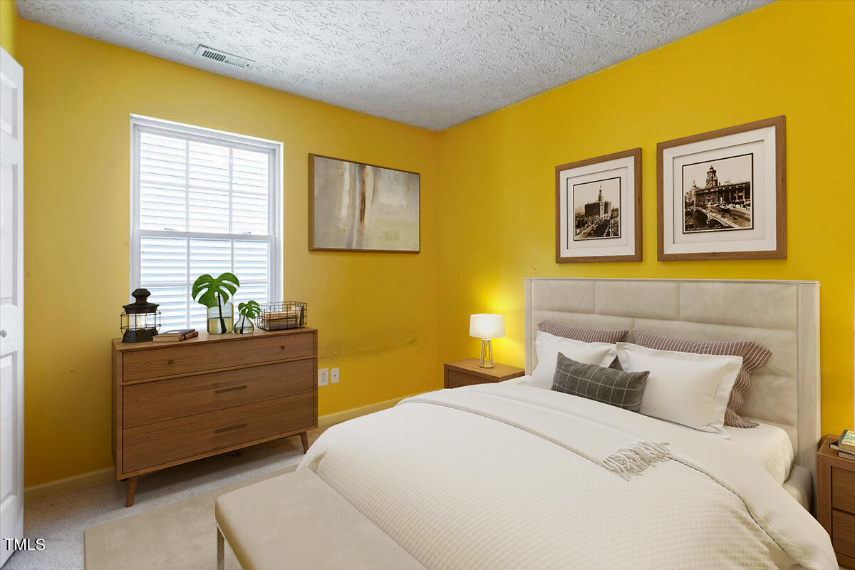 4221 Tensity Drive Raleigh, NC 27604 - Photo 23 of 31 a bedroom with a bed and paintings on the wall