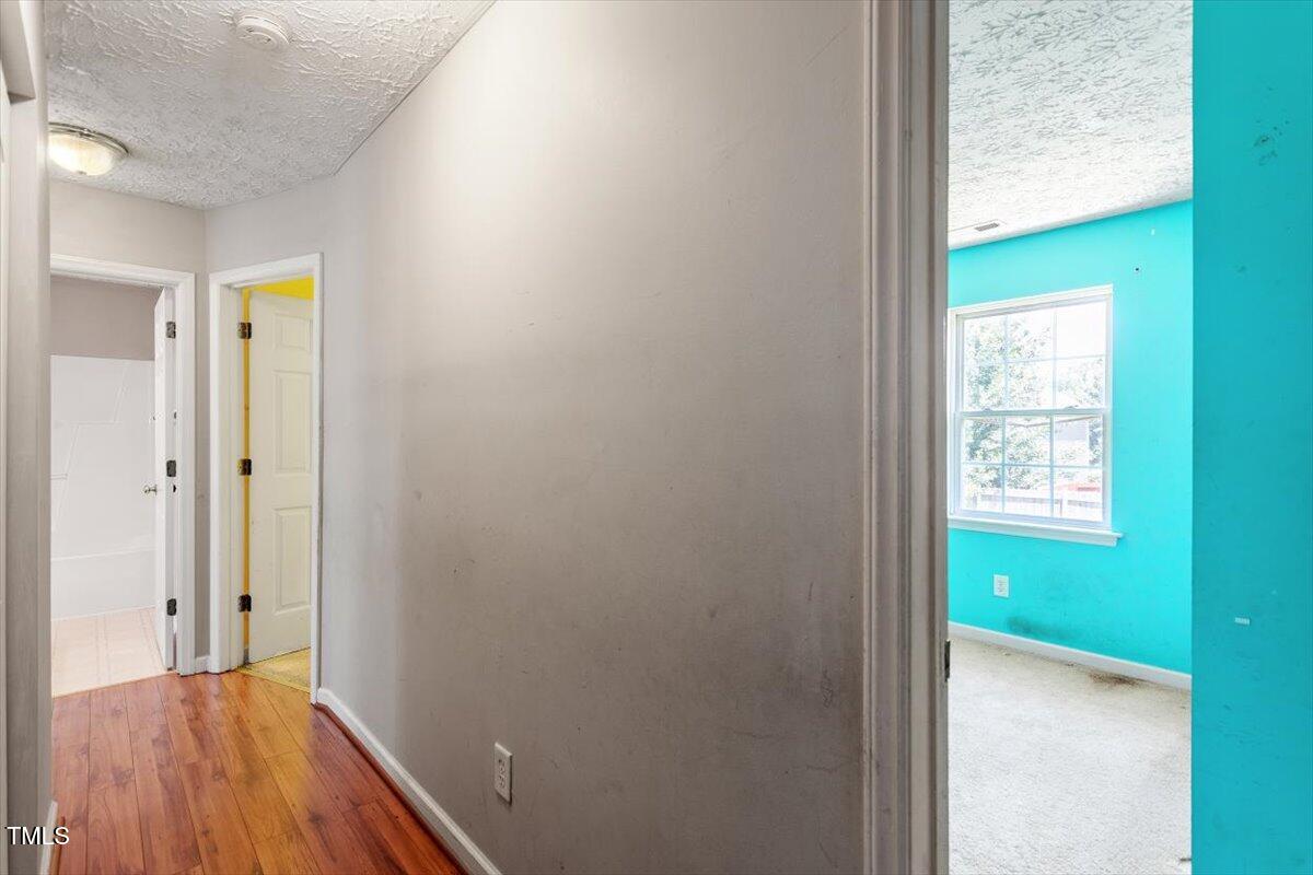 4221 Tensity Drive Raleigh, NC 27604 - Photo 27 of 31 a view of an empty room with wooden floor and a window
