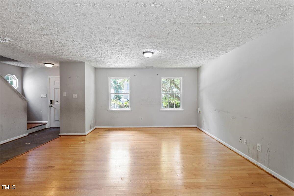 4221 Tensity Drive Raleigh, NC 27604 - Photo 7 of 31 wooden floor in an empty room with a window