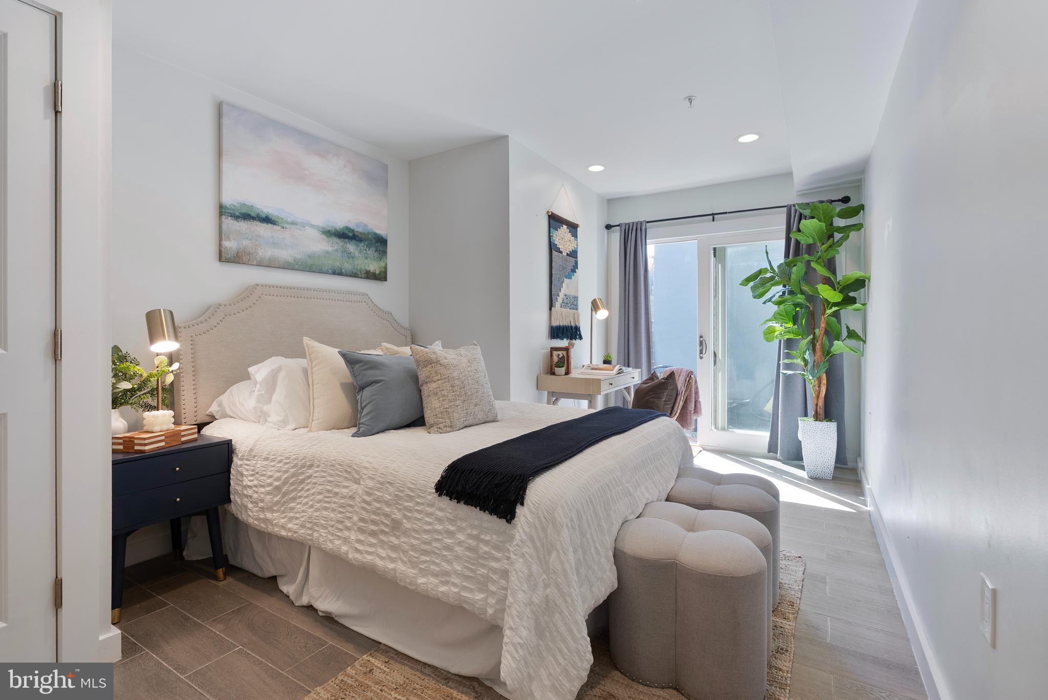 210 Varnum Street Northwest, Unit 1 Washington, DC 20011 - Photo 12 of 22 a bedroom with a bed and a painting on the wall