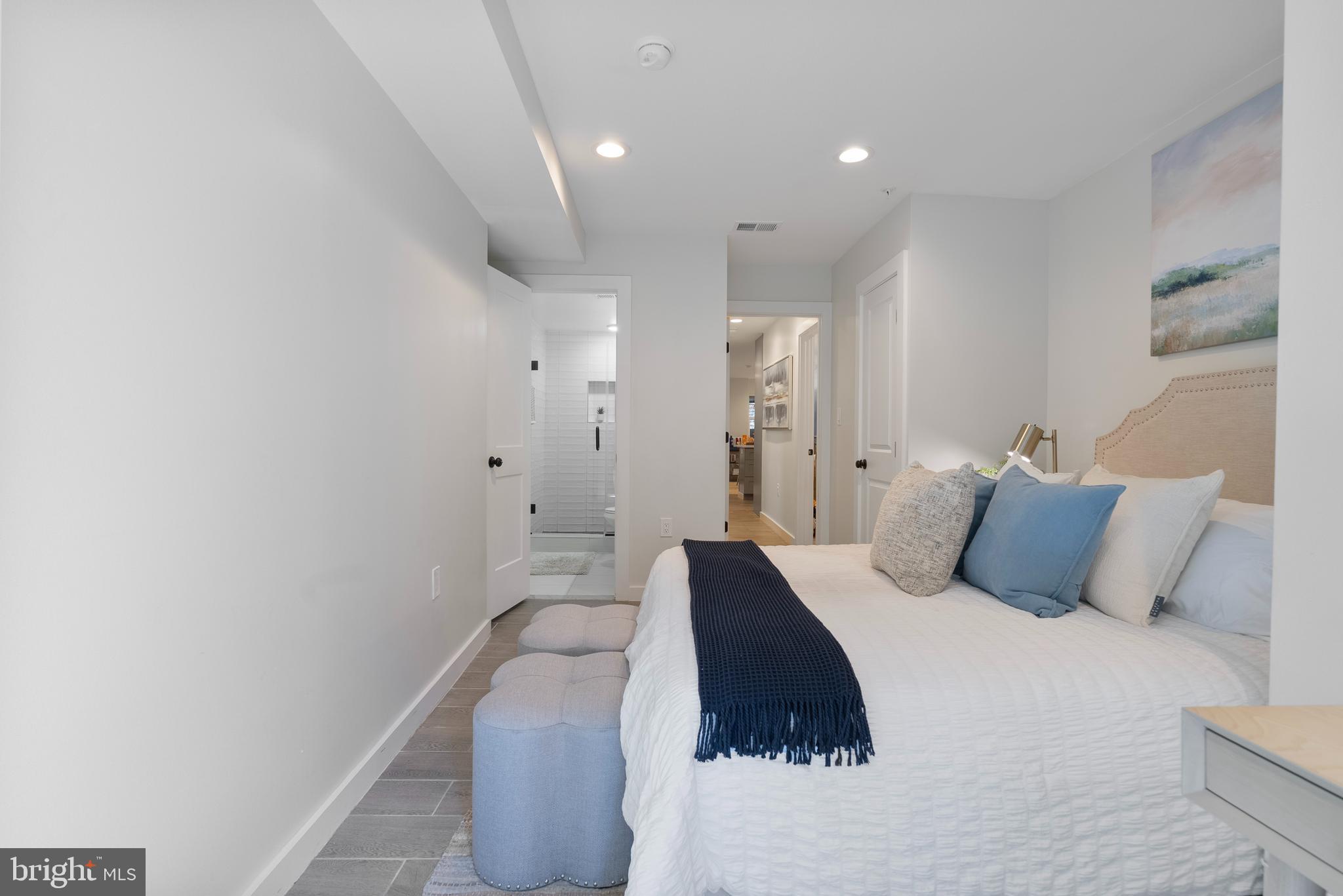 210 Varnum Street Northwest, Unit 1 Washington, DC 20011 - Photo 13 of 22 a bedroom with a large bed and a potted plant