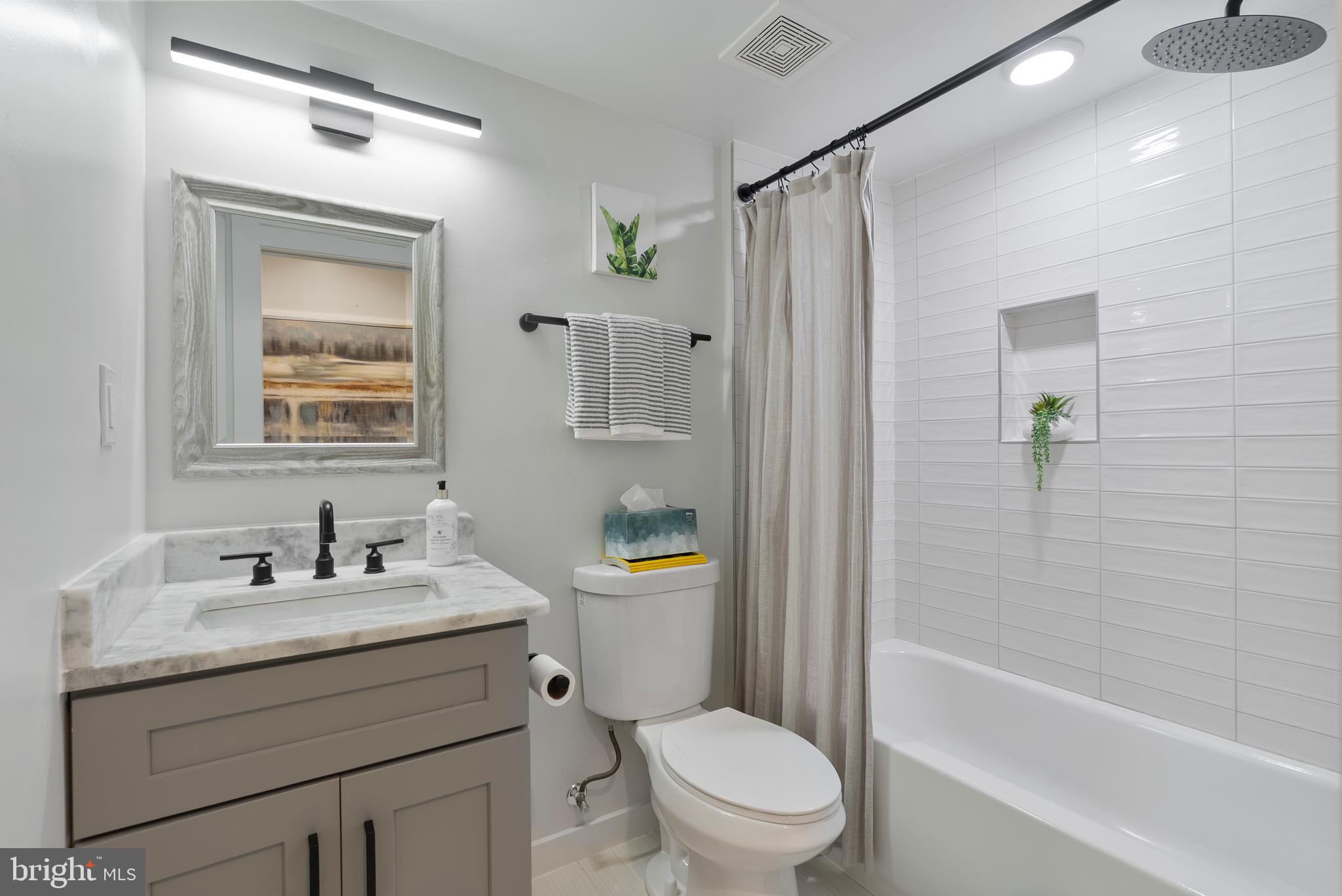 210 Varnum Street Northwest, Unit 1 Washington, DC 20011 - Photo 16 of 22 a bathroom with a sink toilet and shower