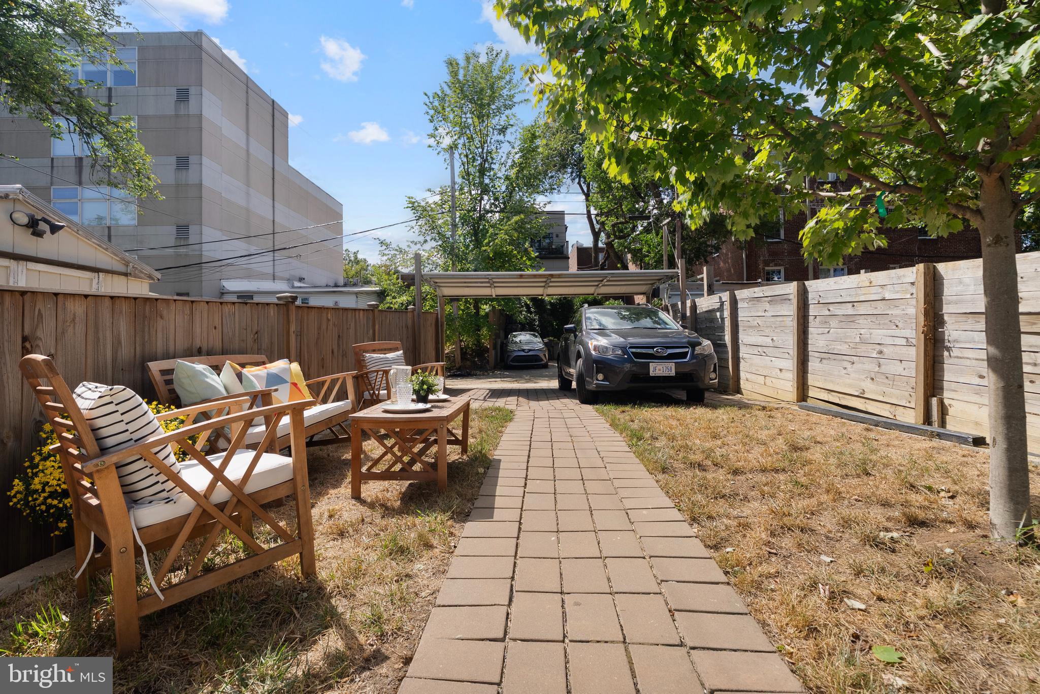 210 Varnum Street Northwest, Unit 1 Washington, DC 20011 - Photo 19 of 22 a view of a patio with table and chairs potted plants with wooden fence