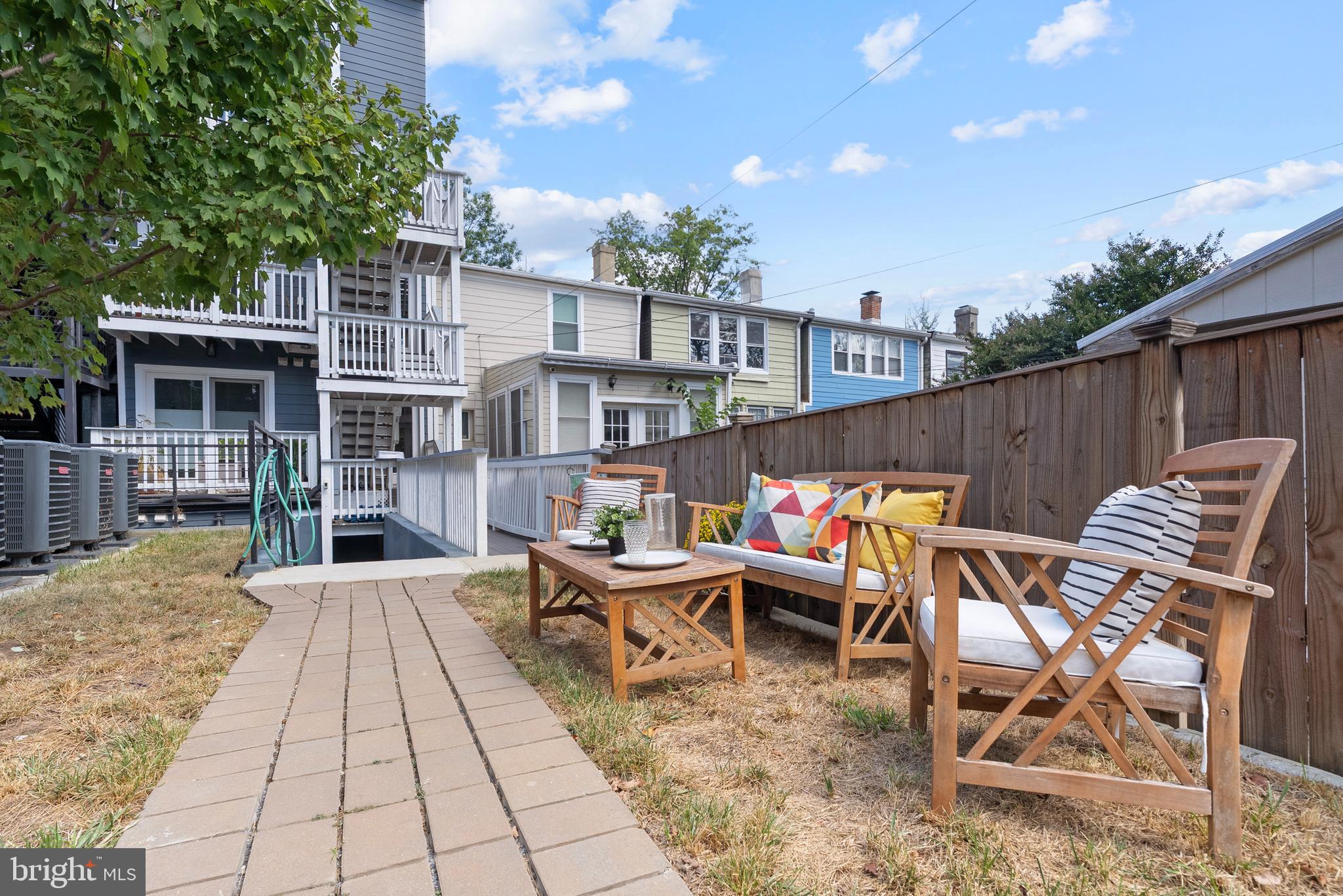 210 Varnum Street Northwest, Unit 1 Washington, DC 20011 - Photo 20 of 22 a backyard of a house with barbeque oven table and chairs